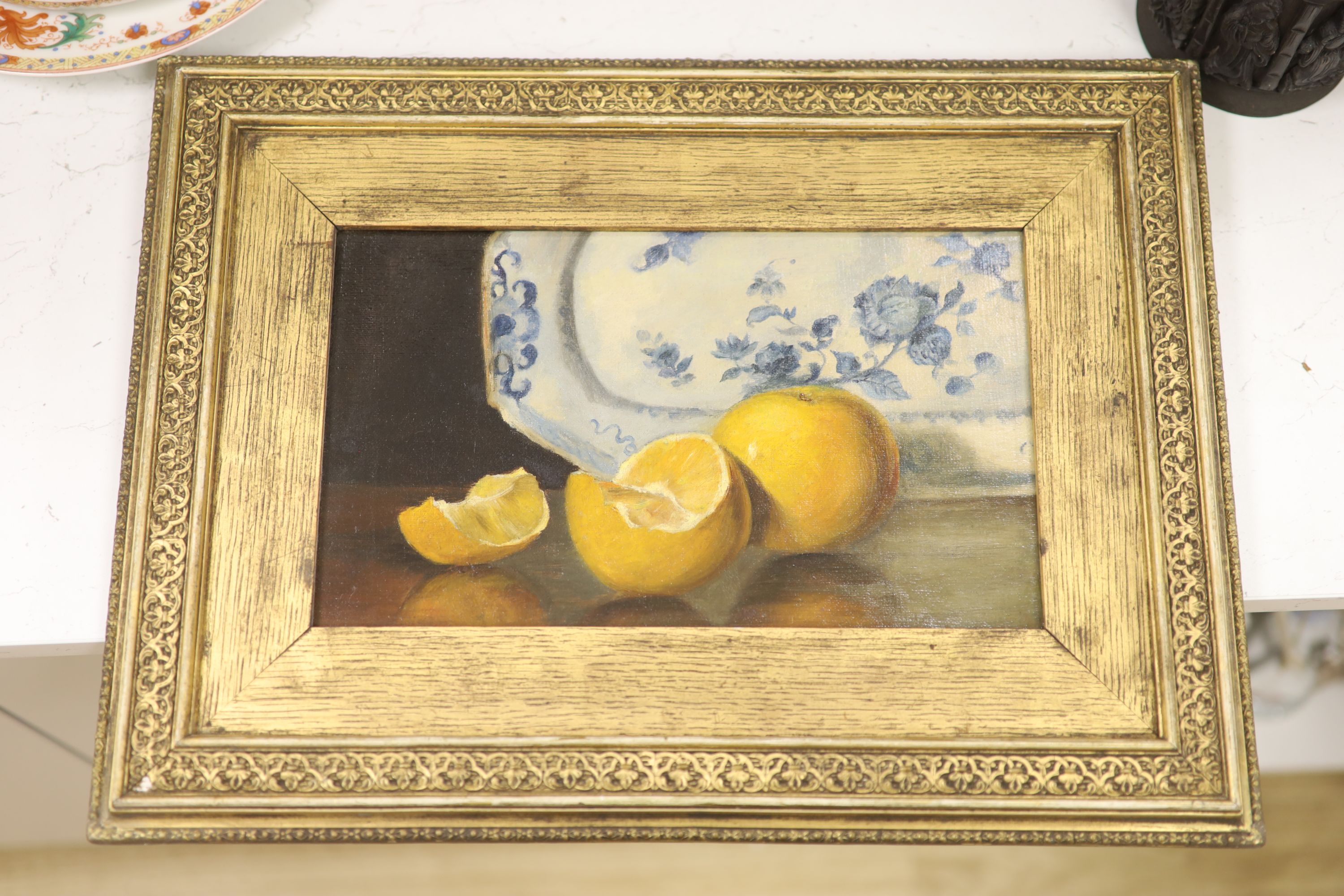 English School c.1900, oil on canvas, Still life of oranges and a delft plate, 17 x 29cm